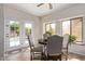 Sunlit breakfast nook featuring backyard view and access to the pool via French doors at 4503 E Elmwood St, Mesa, AZ 85205