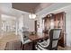 Elegant dining room with tray ceiling, upholstered chairs, and a classic hutch at 4503 E Elmwood St, Mesa, AZ 85205