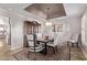 Formal dining room with stylish chairs, elegant lighting fixture, and a display cabinet at 4503 E Elmwood St, Mesa, AZ 85205