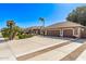 Wide driveway leads to a well-maintained home with a separate two-car garage and lush landscaping at 4503 E Elmwood St, Mesa, AZ 85205