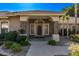 Inviting covered front porch with stone accents, stylish lighting, and lush landscaping at 4503 E Elmwood St, Mesa, AZ 85205