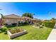 Charming single-story home with mature trees, lush grass, and a well-maintained landscape at 4503 E Elmwood St, Mesa, AZ 85205