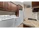 Functional laundry room with ample cabinet space and granite countertops at 4503 E Elmwood St, Mesa, AZ 85205