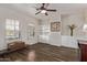 Spacious living room featuring wood-look tile, built-in shelves and cabinets, and plantation shutters at 4503 E Elmwood St, Mesa, AZ 85205