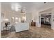 Bright living room with neutral tones, tiled floor, ceiling fan, and view into dining area at 4503 E Elmwood St, Mesa, AZ 85205