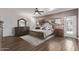 Cozy main bedroom featuring a ceiling fan, wood floors, and a large dresser with a mirror at 4503 E Elmwood St, Mesa, AZ 85205