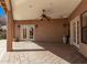 Inviting covered patio featuring brick floors, ceiling fan and direct access to the main house via French doors at 4503 E Elmwood St, Mesa, AZ 85205