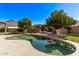 Gorgeous pool with trees, patio furniture, outdoor fireplace and lush landscaping creating a private backyard oasis at 4503 E Elmwood St, Mesa, AZ 85205