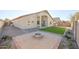 Backyard featuring a circular fire pit, small patch of grass, and block fence at 4514 W Ellis St, Laveen, AZ 85339