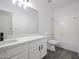 Bathroom featuring vanity with sleek fixtures, toilet, tub with shower, and wood-look flooring at 4514 W Ellis St, Laveen, AZ 85339