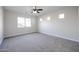 Neutral bedroom with carpet, ceiling fan, natural light, and multiple windows at 4514 W Ellis St, Laveen, AZ 85339