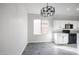 Well-lit kitchen featuring granite countertops, modern lighting, and a breakfast bar at 4514 W Ellis St, Laveen, AZ 85339