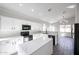 Modern white kitchen featuring an island, black appliances, and ample counter space at 4514 W Ellis St, Laveen, AZ 85339