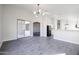 Open-concept living room with sliding glass doors, neutral paint, and wood-look tile flooring at 4514 W Ellis St, Laveen, AZ 85339