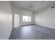 Open-concept living room featuring archways, neutral paint, wood-look tile and ceiling fan at 4514 W Ellis St, Laveen, AZ 85339