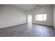 Spacious living room featuring neutral paint, wood-look tile and abundant natural light at 4514 W Ellis St, Laveen, AZ 85339