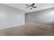 A spacious, carpeted bedroom featuring a modern ceiling fan at 4718 E Pearl Rd, San Tan Valley, AZ 85143