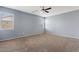 Comfortable bedroom with neutral carpet and natural light from two windows at 4718 E Pearl Rd, San Tan Valley, AZ 85143