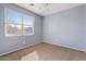 Cozy bedroom featuring a ceiling fan and large window for ample sunlight at 4718 E Pearl Rd, San Tan Valley, AZ 85143