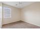 Standard bedroom with neutral carpet, a ceiling fan, and a window with horizontal blinds at 4718 E Pearl Rd, San Tan Valley, AZ 85143