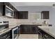 Well-equipped kitchen featuring stainless steel appliances, modern countertops, and dark wood cabinetry at 4718 E Pearl Rd, San Tan Valley, AZ 85143