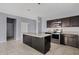 Modern kitchen with a center island, stainless steel appliances, granite countertops, and tile flooring at 4718 E Pearl Rd, San Tan Valley, AZ 85143