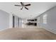 Open-concept living space with tile flooring flowing into a carpeted area, ideal for relaxation at 4718 E Pearl Rd, San Tan Valley, AZ 85143