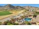 Beautiful desert landscape, and backyard with a pool, spa, bar, and golf course view at 4820 N 210Th Ave, Buckeye, AZ 85396