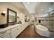 Large bathroom with soaking tub, dual vanities, custom mirrors and lots of natural light at 4820 N 210Th Ave, Buckeye, AZ 85396