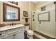 Bathroom with a glass shower, tiled accents, and a vanity with a framed mirror at 4820 N 210Th Ave, Buckeye, AZ 85396