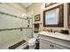 Bathroom featuring a glass shower with decorative tiles and a modern sink vanity at 4820 N 210Th Ave, Buckeye, AZ 85396