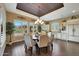 Formal dining room with views to the backyard, with an elegant chandelier and custom window shutters at 4820 N 210Th Ave, Buckeye, AZ 85396