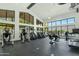 Modern fitness center with floor-to-ceiling windows overlooking mountain views and community landscaping at 4820 N 210Th Ave, Buckeye, AZ 85396