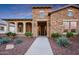 Inviting stone home featuring manicured landscaping and a welcoming front entrance at 4820 N 210Th Ave, Buckeye, AZ 85396