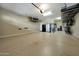 Spacious three-car garage with epoxy floors and ample overhead storage at 4820 N 210Th Ave, Buckeye, AZ 85396