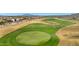 Aerial view of a well-manicured golf course, and community at 4820 N 210Th Ave, Buckeye, AZ 85396