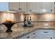 Kitchen counter with granite countertops, custom backsplash, upper cabinets and under cabinet lighting at 4820 N 210Th Ave, Buckeye, AZ 85396