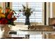 A beautifully decorated kitchen sink area with shutters allowing natural sunlight to come in at 4820 N 210Th Ave, Buckeye, AZ 85396