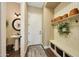 Entryway/mud room with a bench, hooks, shelving, and a view to the powder room at 4820 N 210Th Ave, Buckeye, AZ 85396