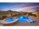 Resort-style pool and hot tub with outdoor kitchen and golf course views; perfect for relaxing and entertaining at 4820 N 210Th Ave, Buckeye, AZ 85396