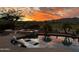 Pool with floating lounge chairs and spa offers stunning views of sunset and mountain at 4820 N 210Th Ave, Buckeye, AZ 85396