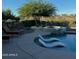 Luxury pool and spa feature in-pool loungers and a cozy firepit seating area at 4820 N 210Th Ave, Buckeye, AZ 85396