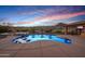 Stunning pool area with a built-in hot tub, chaise loungers, and covered patio at 4820 N 210Th Ave, Buckeye, AZ 85396