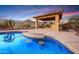 Spectacular pool with swim up seating, outdoor kitchen, and mountain views, a true backyard paradise at 4820 N 210Th Ave, Buckeye, AZ 85396