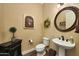 Powder room featuring a pedestal sink, decorative art, and stylish fixtures at 4820 N 210Th Ave, Buckeye, AZ 85396