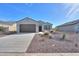 Inviting single-story home with desert landscaping, a two-car garage, and a covered entryway at 5091 N Bryce Canyon Dr, Eloy, AZ 85131