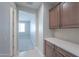 Hallway features tile flooring, cabinets, and an open view to the carpeted bedroom with natural light at 5091 N Bryce Canyon Dr, Eloy, AZ 85131