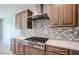 This gourmet kitchen features stainless steel appliances, granite countertops, and custom backsplash at 5091 N Bryce Canyon Dr, Eloy, AZ 85131