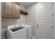 Bright laundry room with a washer, dryer, storage cabinets, and access to the exterior of the home at 5091 N Bryce Canyon Dr, Eloy, AZ 85131