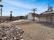 Backyard featuring pool, desert landscaping, stone accents, palm trees, clear blue sky at 5432 E Juniper Ave, Scottsdale, AZ 85254